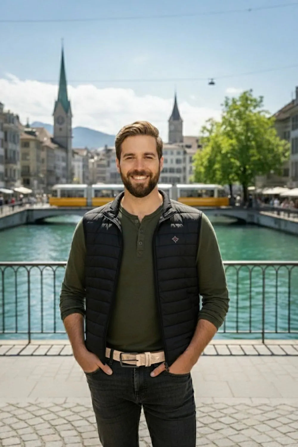 Mann trägt beigen Appenzeller Ledergürtel von Edelvetica vor der Limmat in Zürich mit klassischer Altstadt im Hintergrund